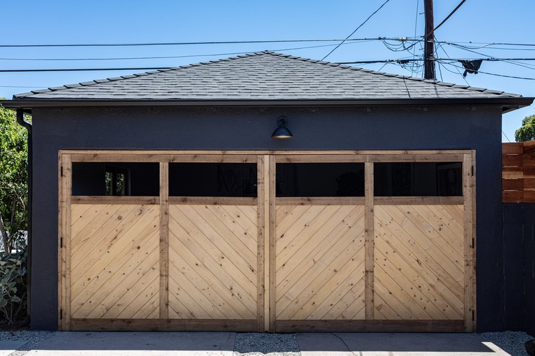 A wooden garage door with a herringbone pattern