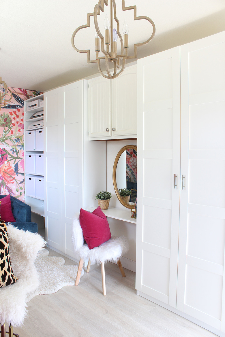 Garage office with chandelier and white faux fur on desk chair