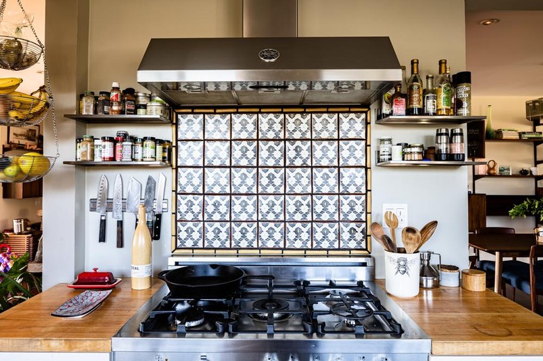 gas stovetop with feature tiled backsplash