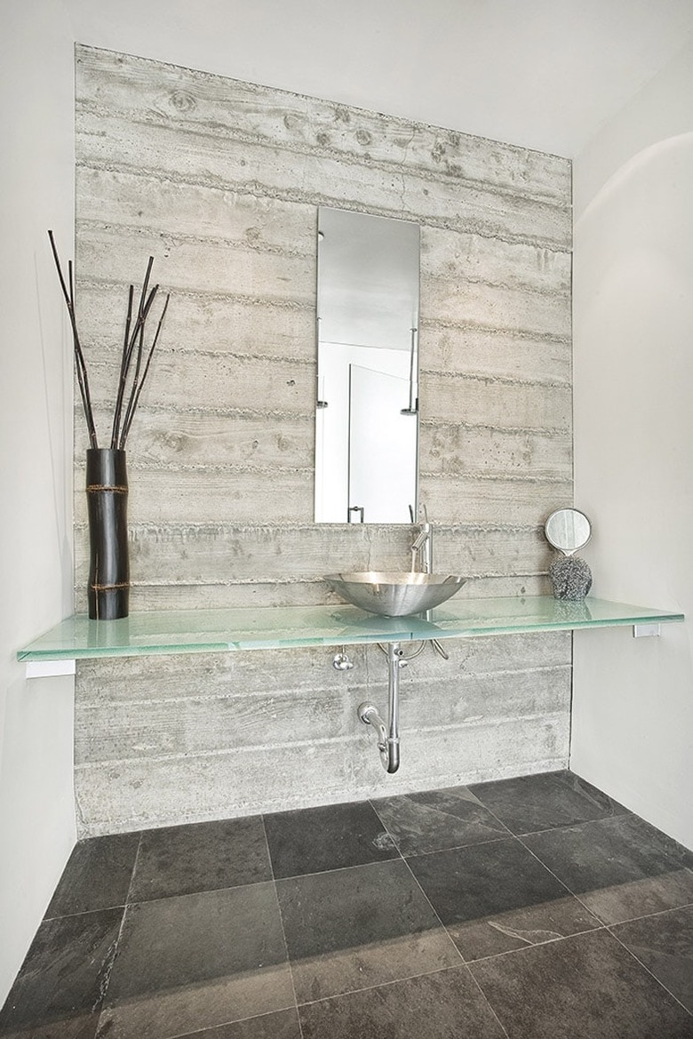 floating glass bathroom countertop in airy gray bathroom