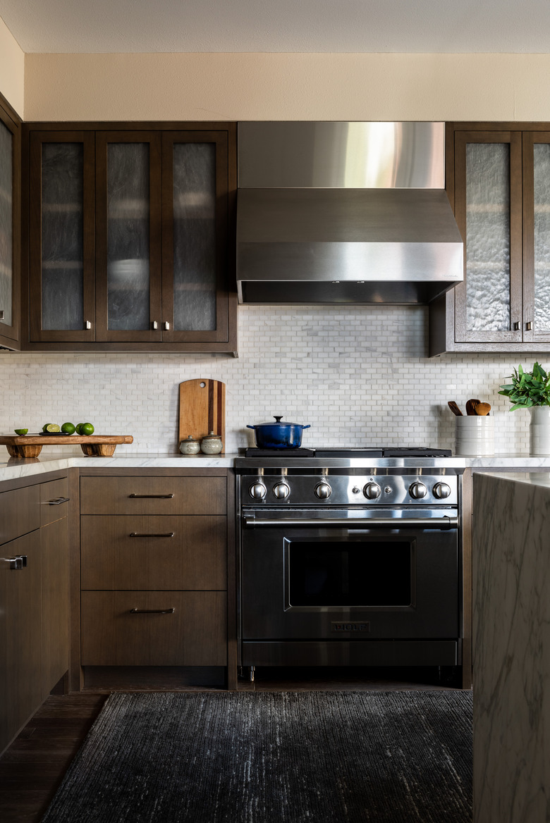 kitchen space with dark wood cabinets and glass doors