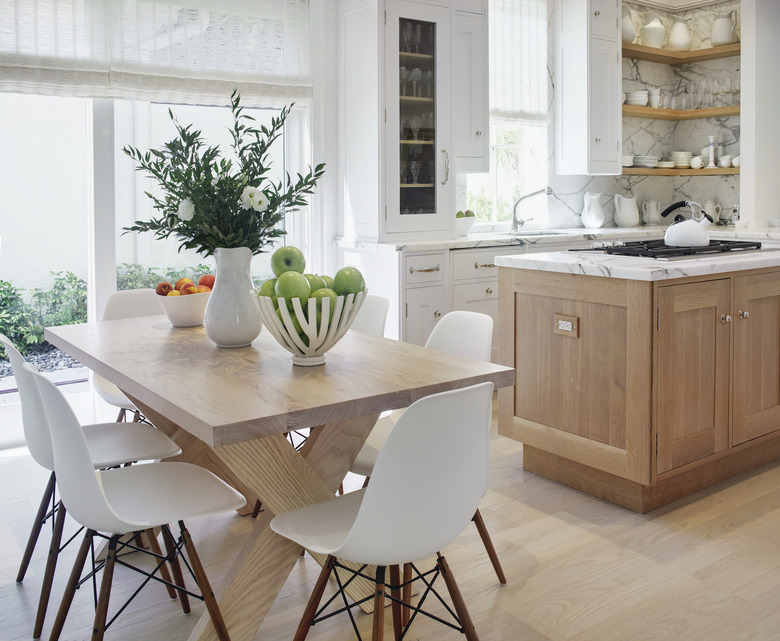 kitchen space with wood table and white chairs