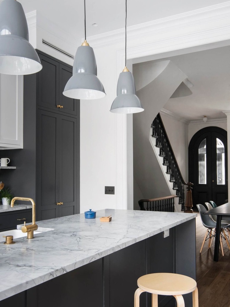 gray and white kitchen with gray pendant lights over island