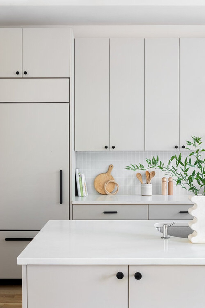 gray and white kitchen with black hardware