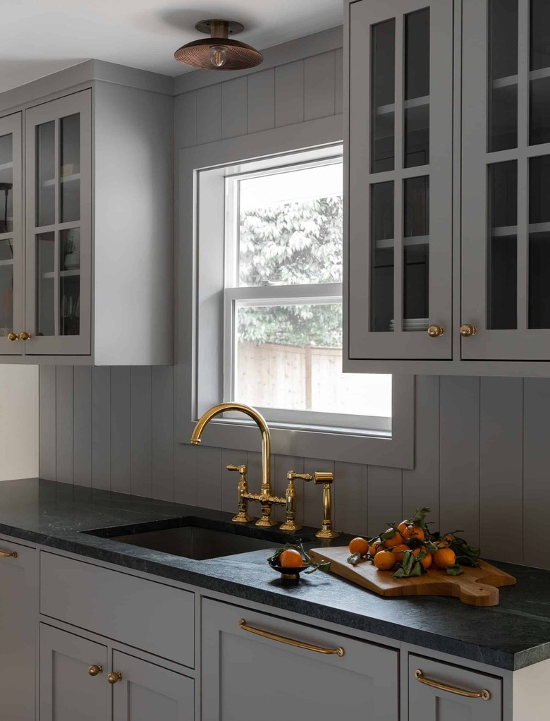 gray kitchen with brass hardware