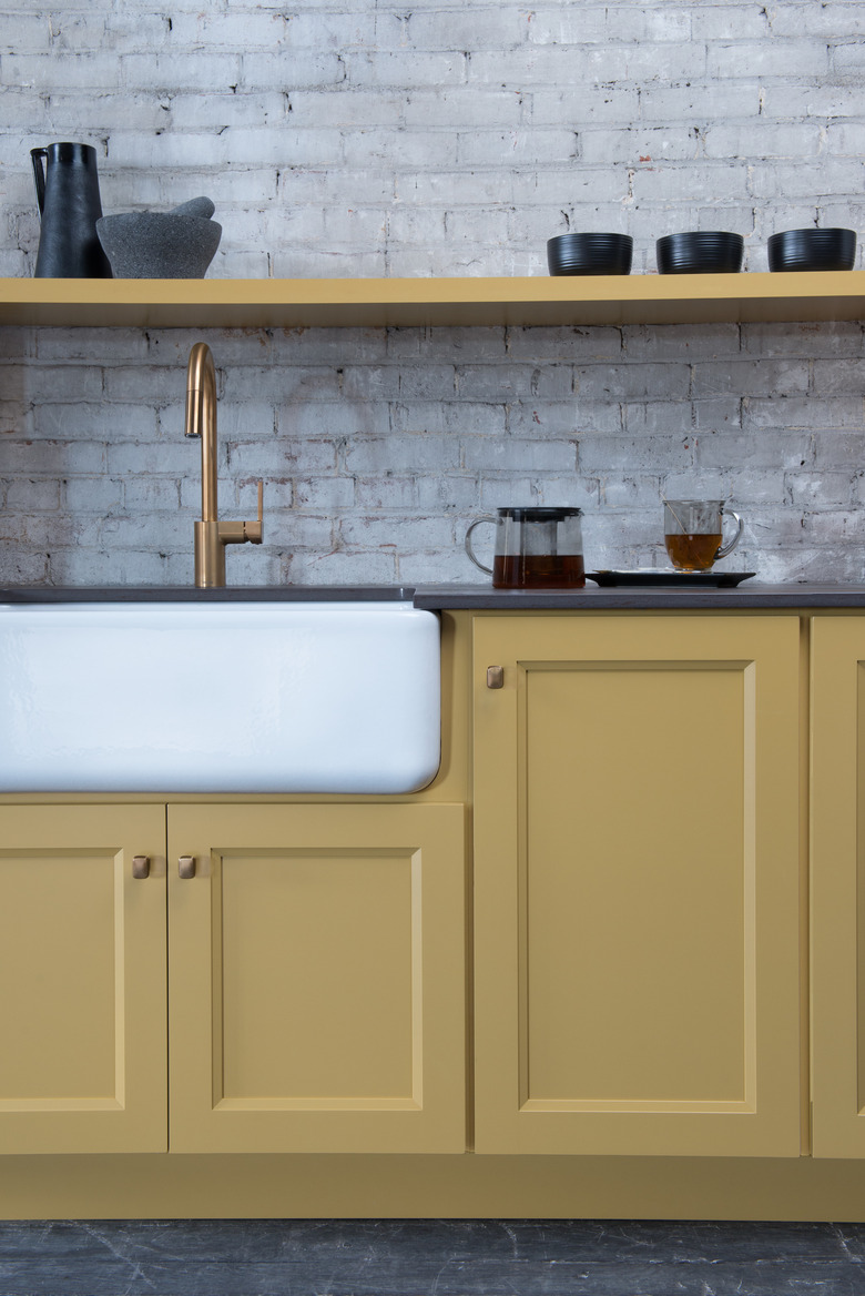 kitchen with yellow cabinets and shelves