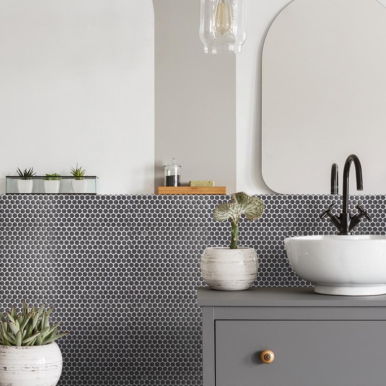 bathroom backsplash idea with gray penny tile behind vessel sink