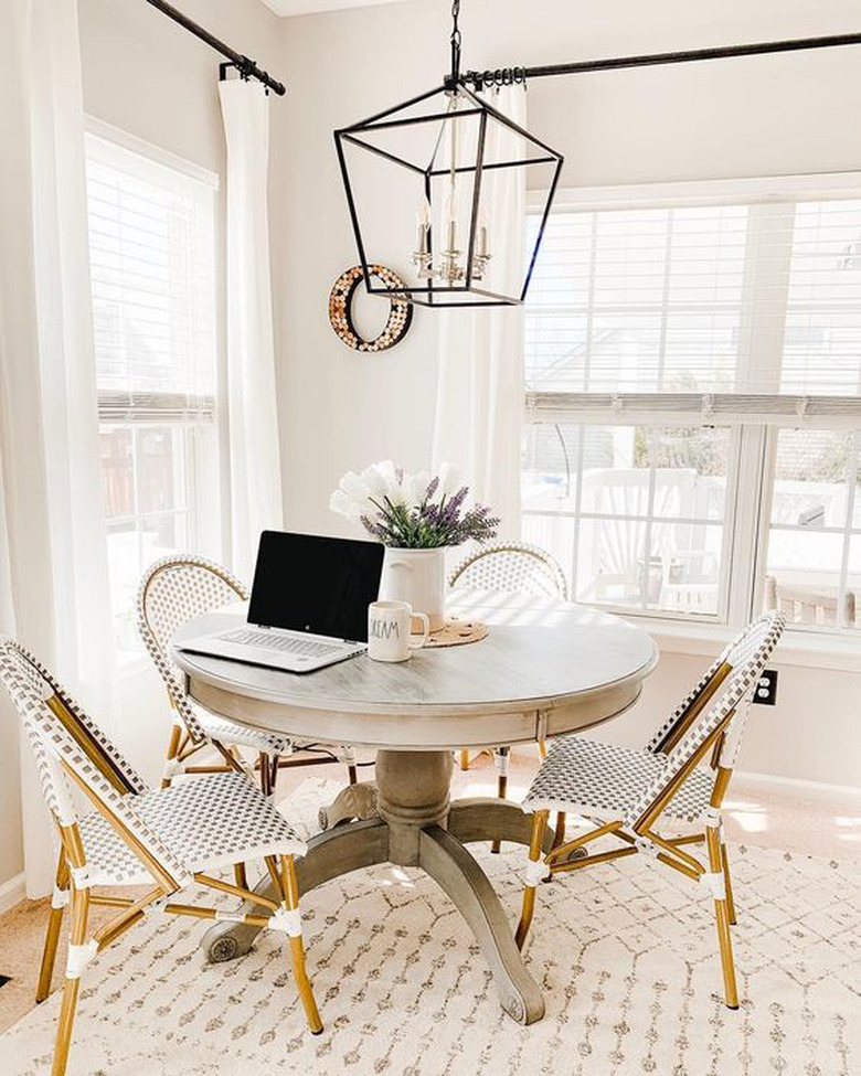 gray dining room with round table and bistro style chairs