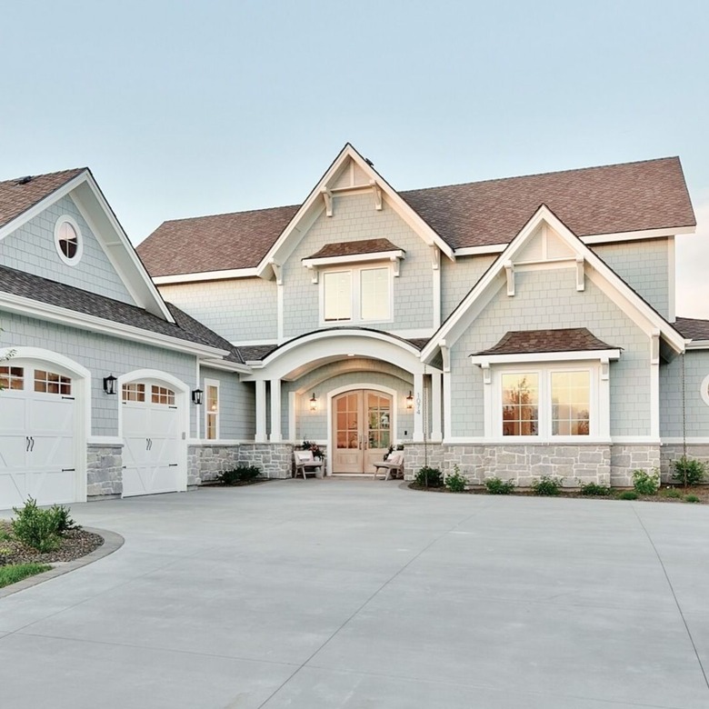 blue gray exterior paint with double doors and large driveway