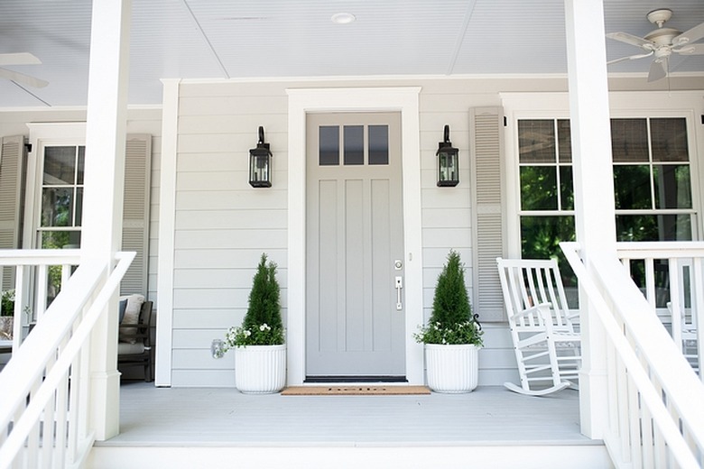 craftsman with gray exterior paint on siding and front door and plants on the porch