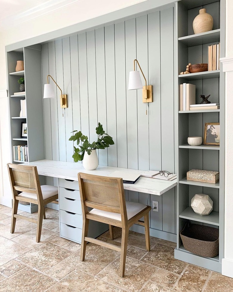 gray workspace with built-ins and brass wall sconces