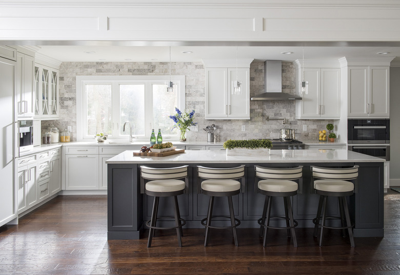 classic gray kitchen island with wood detailing on a glossy wooden floor