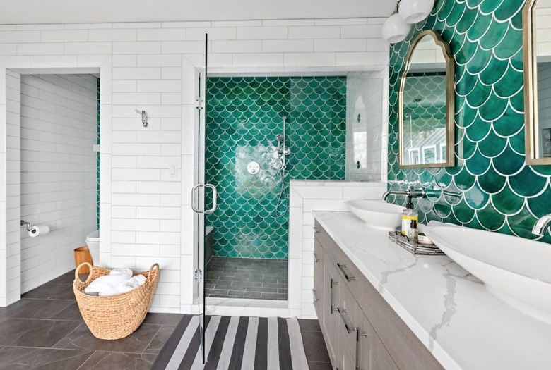 Bathroom with green tile backsplash, white sink area, green tile shower.