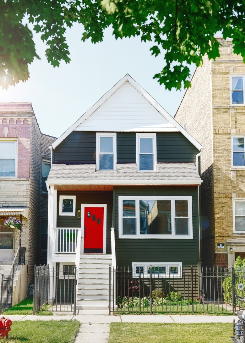 Green exterior house paint with white trim and red door