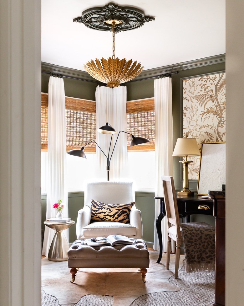 Green home office with animal print touches and brass finishes