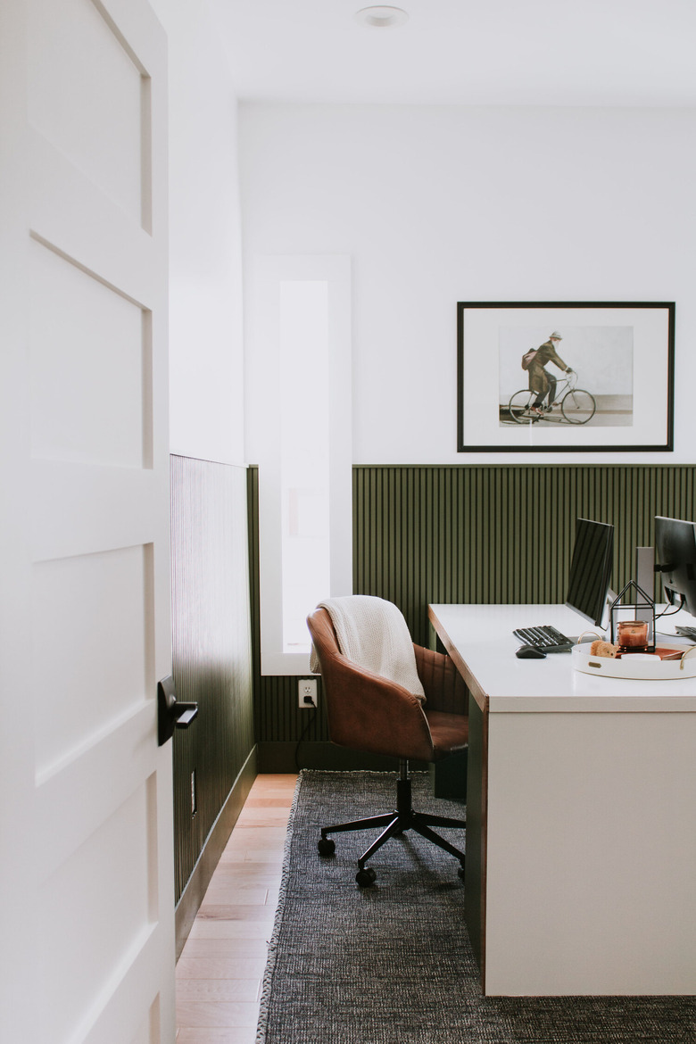 Green home office with wainscoting and modern decor