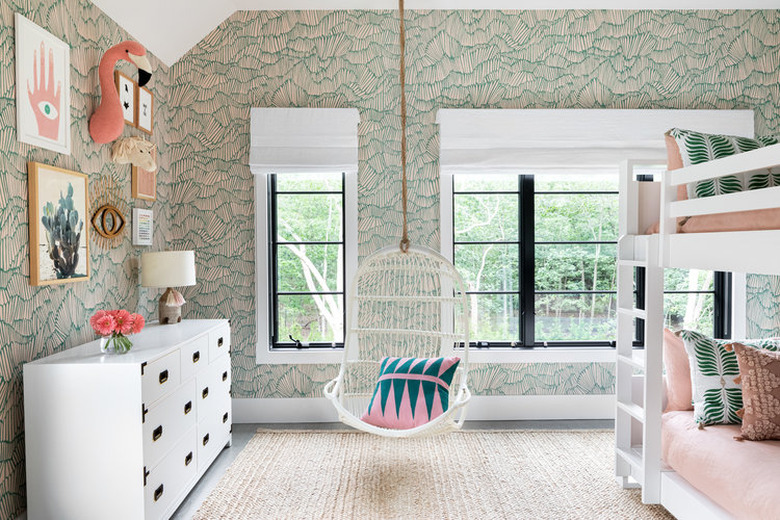 green kids bedroom idea with abstract wallpaper, swing chair