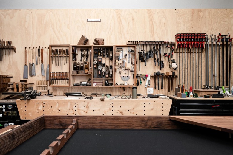 A woodworking studio with tools, wood walls and storage