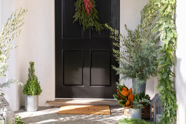 front door christmas decorations with red and green door swag and fresh greenery