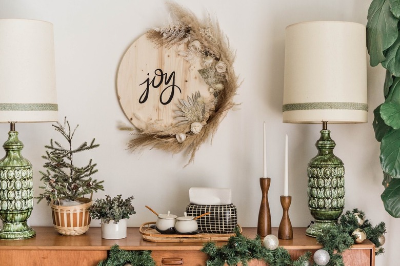 Christmas wood Joy sign with dried plants and midcentury decor