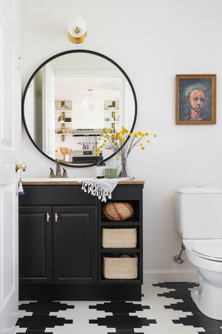 white half bathroom idea with black vanity cabinet and patterned tile flooring