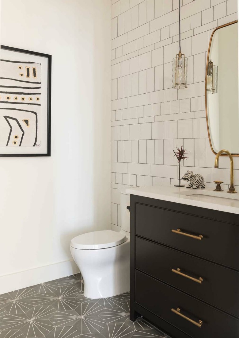 half bathroom idea with black cabinet and patterned tile floor