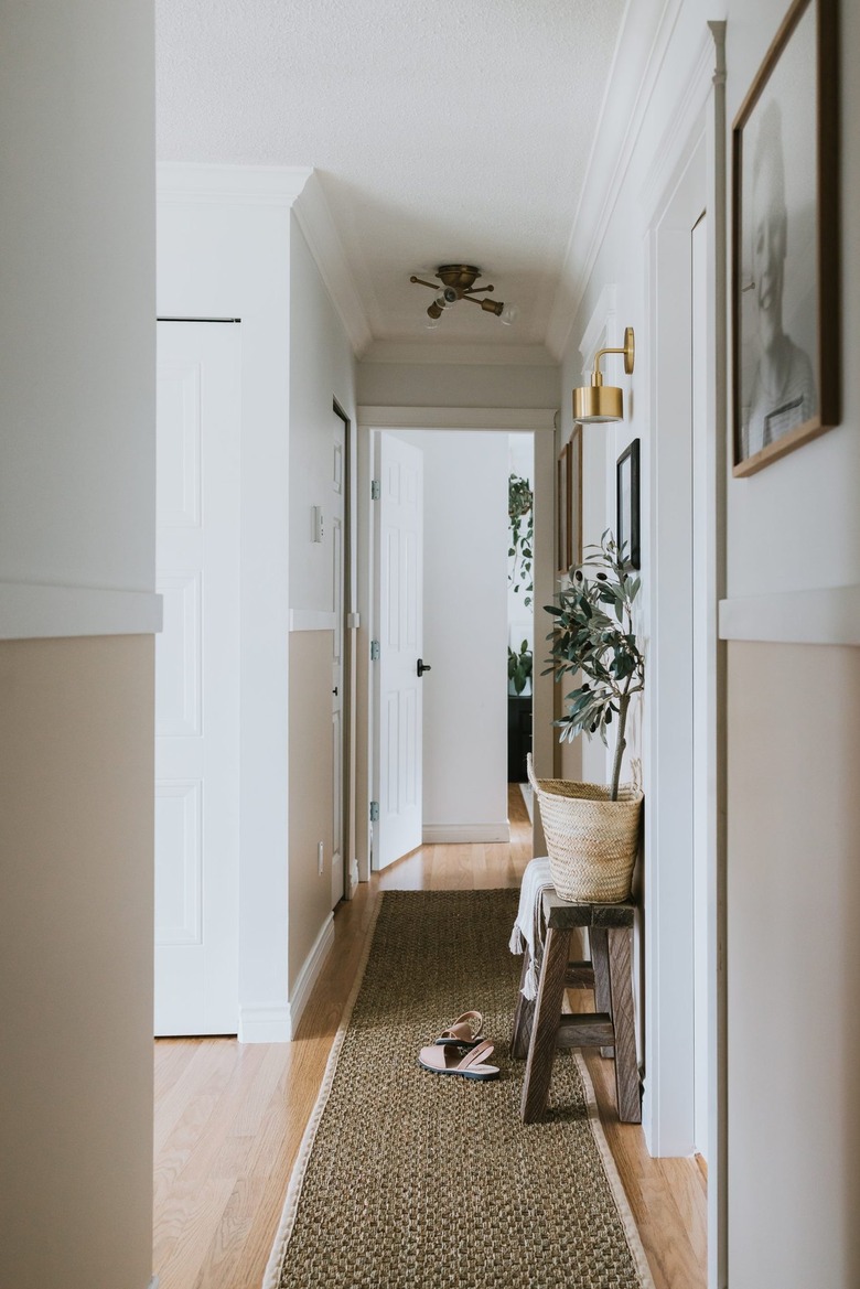 two tone narrow hallway with molding