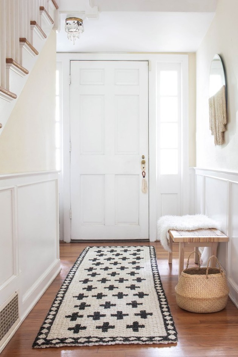 white hallway with handpainted jute rug