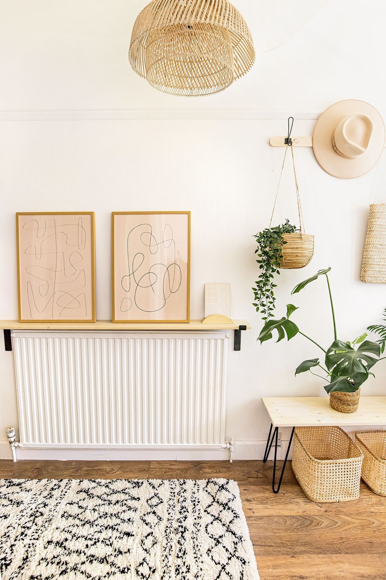 boho hallway with shelf over radiator and abstract artwork