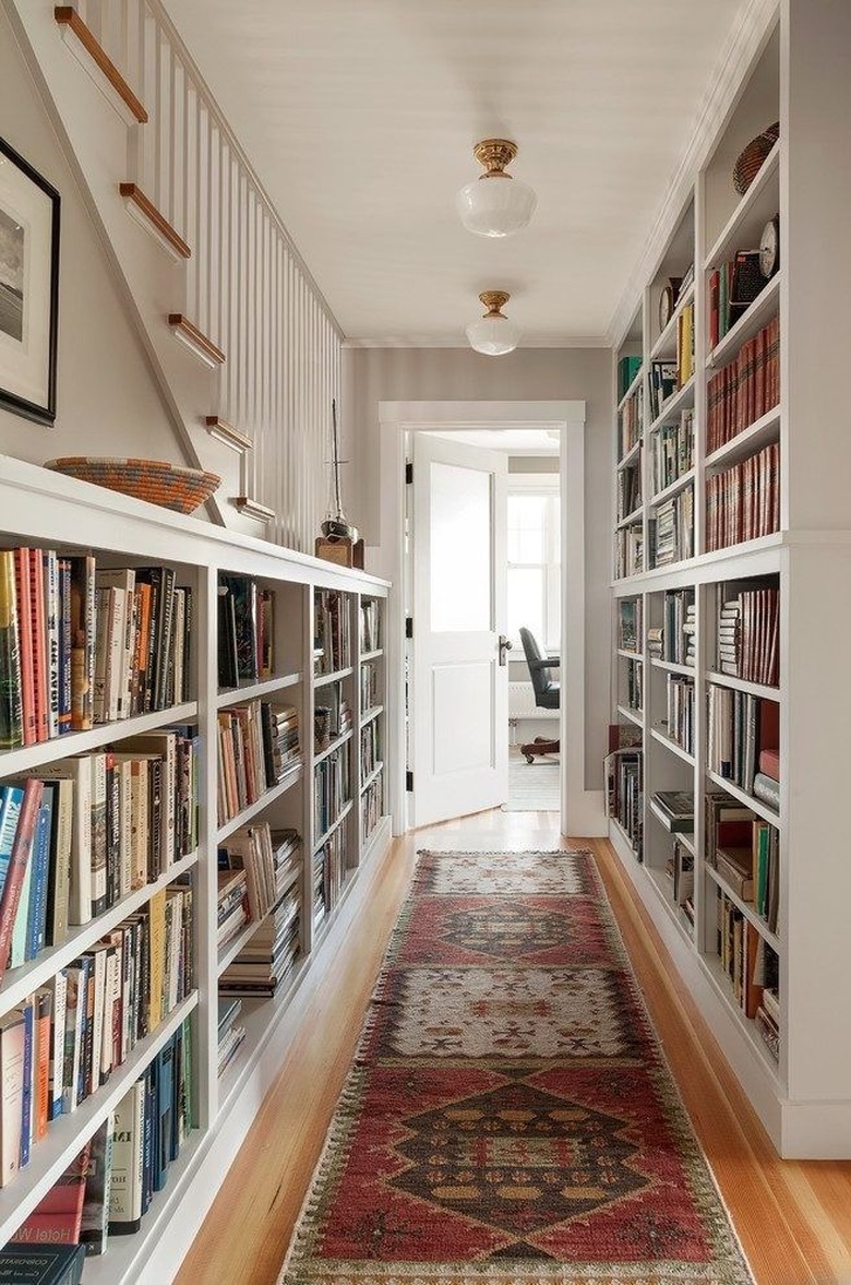 Hallway Focal Point Ideas in cream hallways with bookshelves along wall