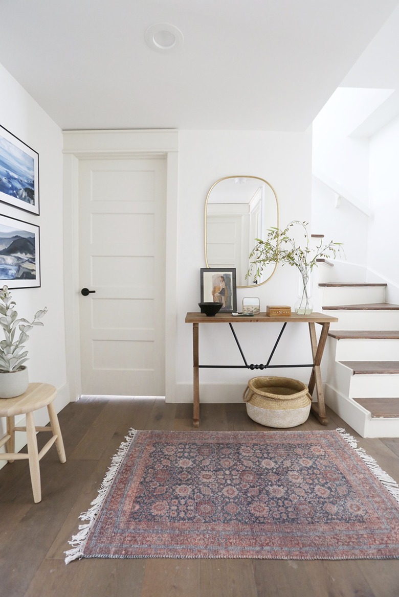 wood and metal table with mirror in entryway