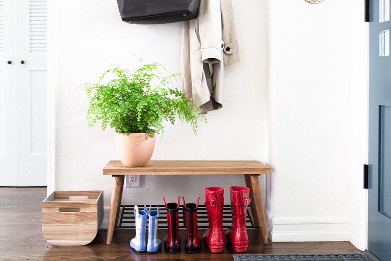 entryway with wooden bench and potted plant