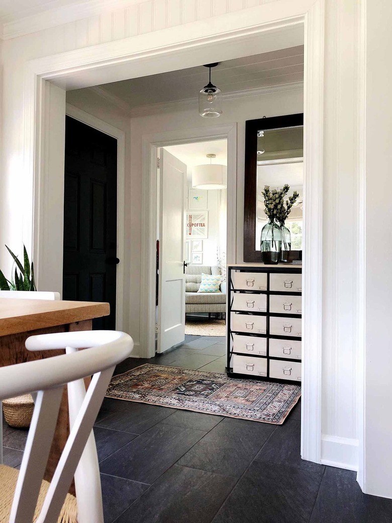 industrial drawers and vintage rug in entryway