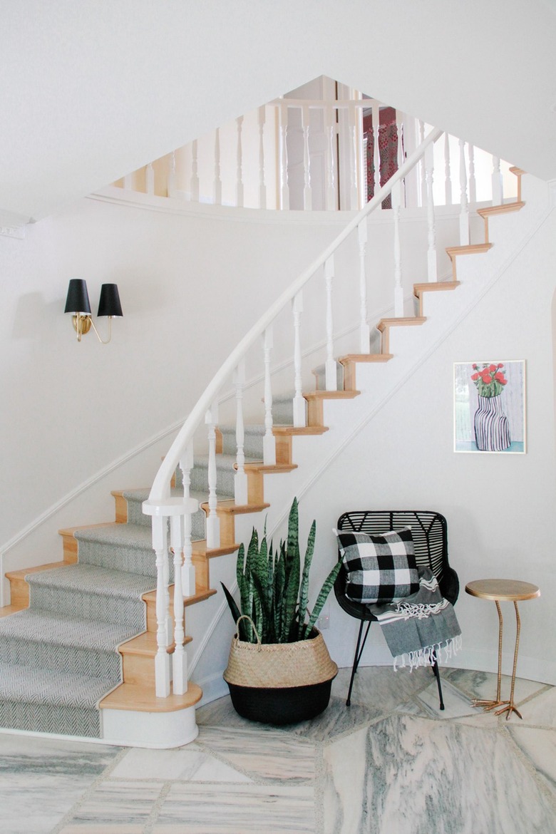 black rattan chair and snake plant in entryway