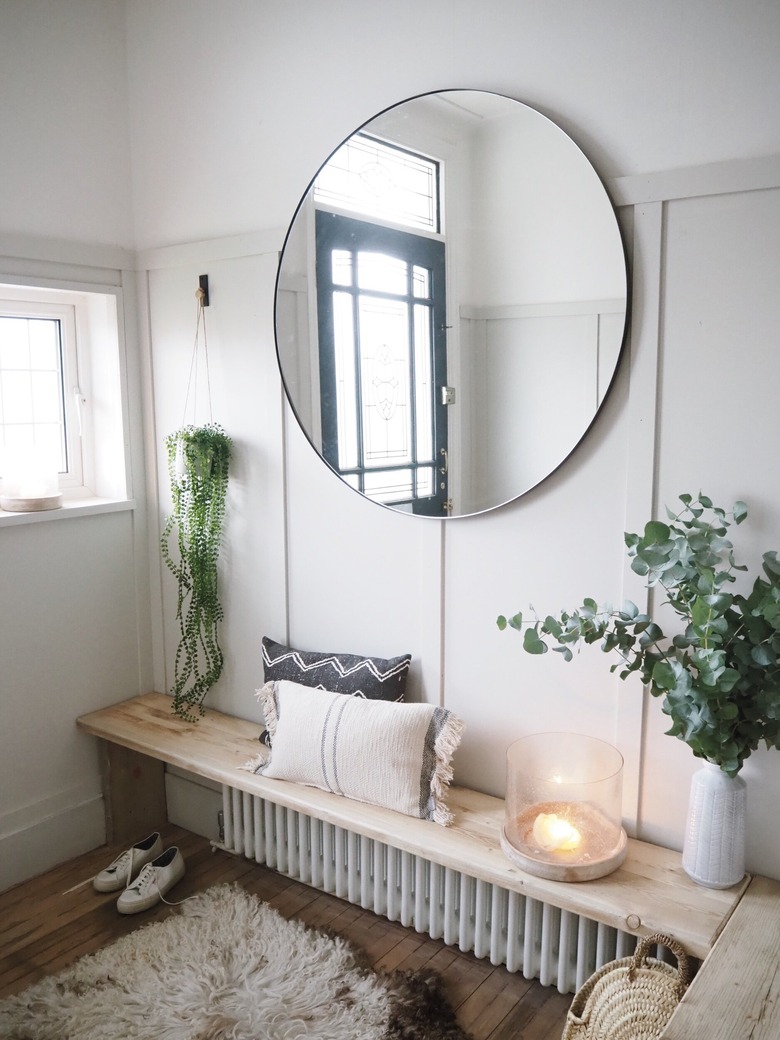 Hallway Makeover Ideas in gray paneled hallway with diy storage bench and large mirror