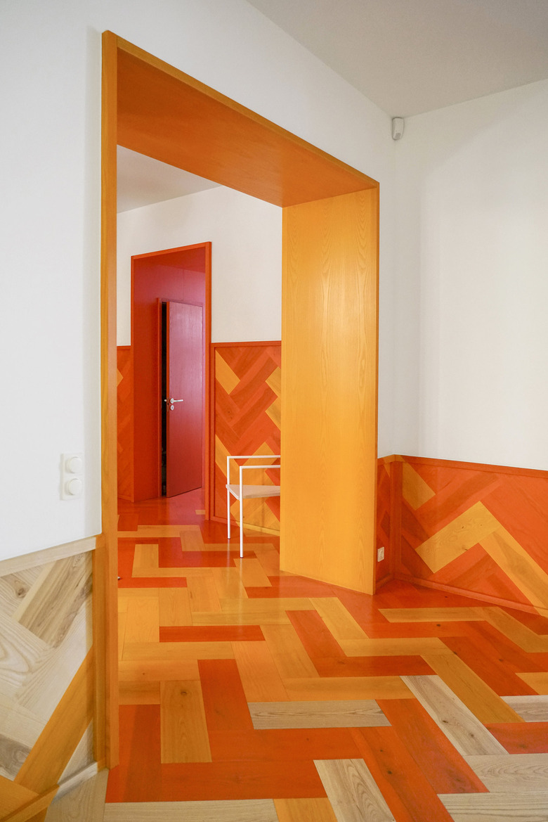 Orange door, floors, and walls in hallway