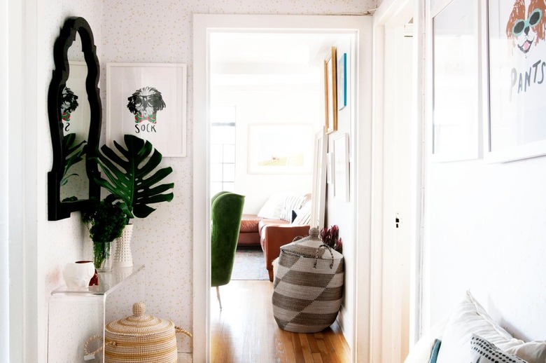 hallway with mirror and plants