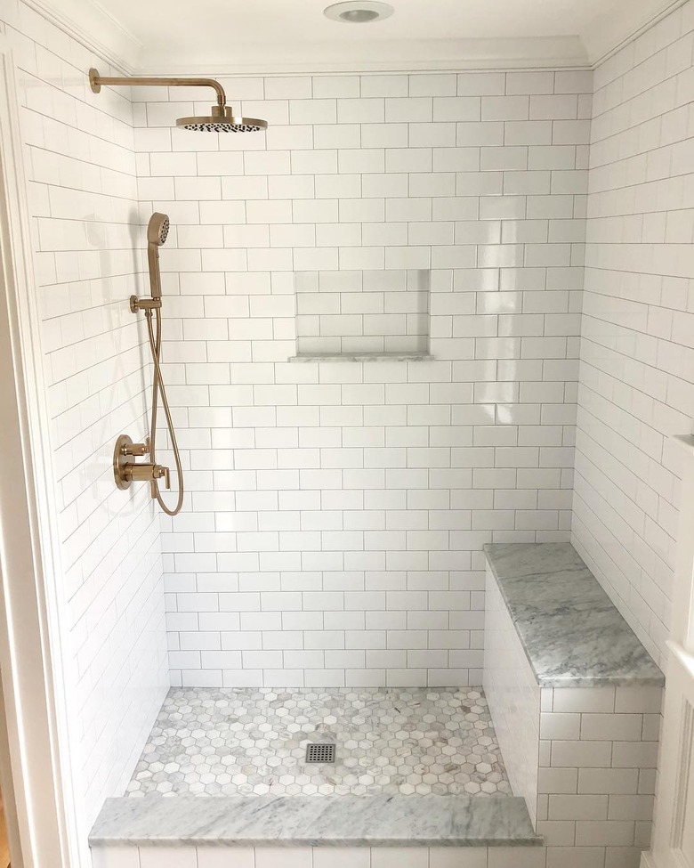 Brass handheld showerhead with rain shower and white subway tile