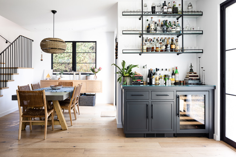 dining area with bar and blonde wood flooring