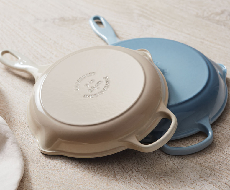 off-white and light blue cast iron skillets