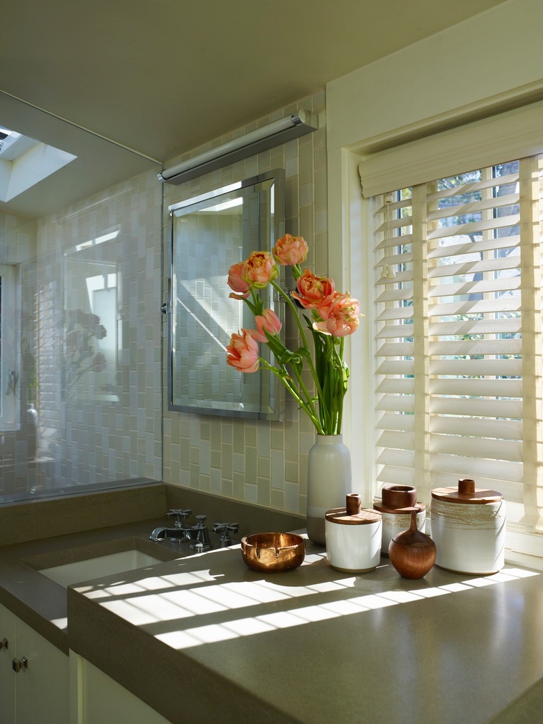 Bathroom in earth tones with tile backsplash and cement countertop