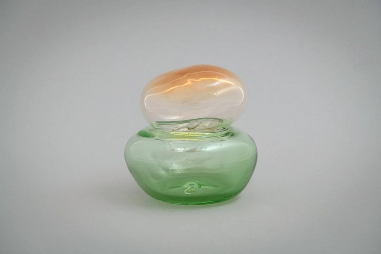 A green and orange glass sculpture