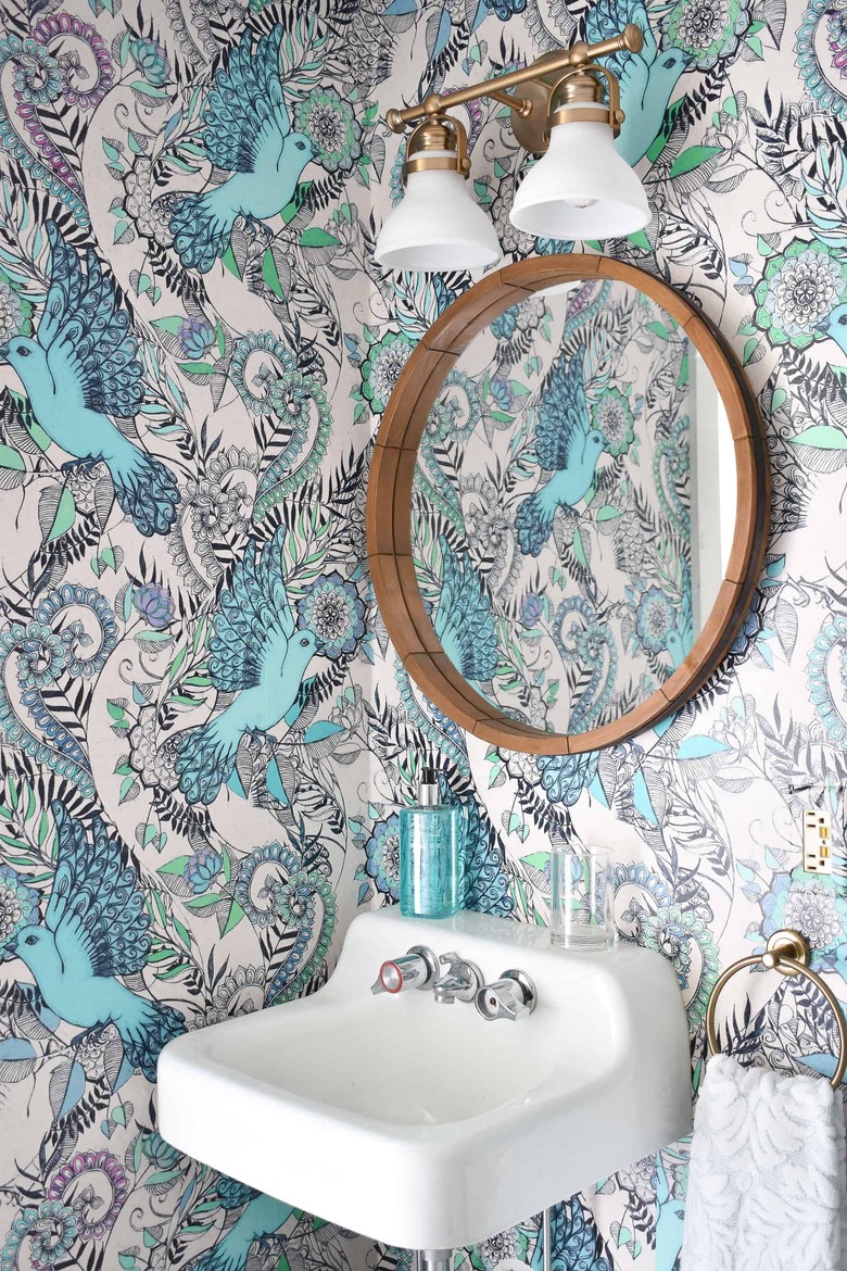 turquoise and white removable bathroom wallpaper print with bird pattern and wall-mounted sink