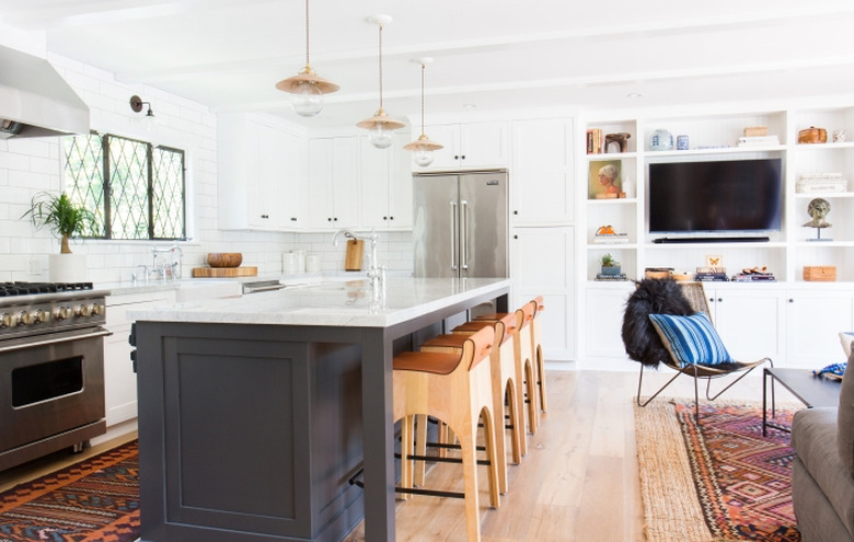 hardwood kitchen flooring with white cabinets and white countertops