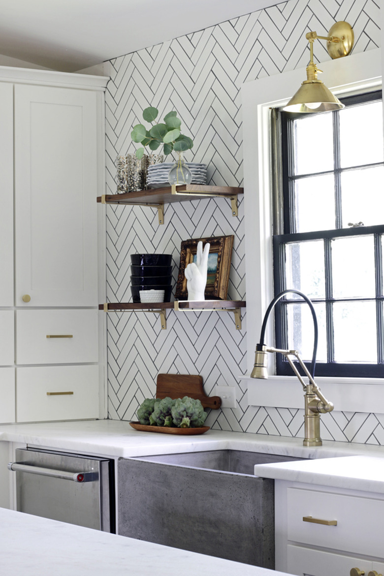 White herringbone backsplash with dark gray grout in white kitchen