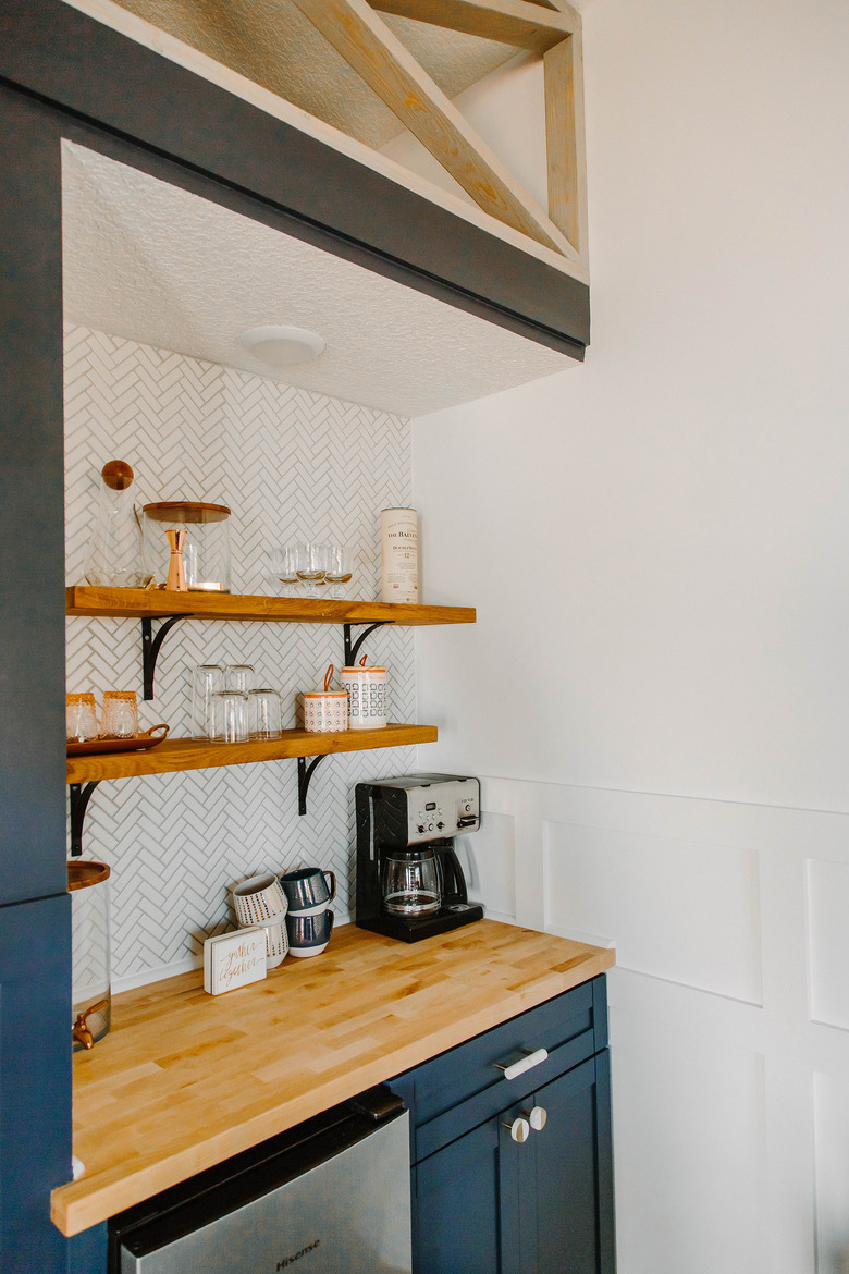 White herringbone backsplash with coffee bar and floating wood shelves