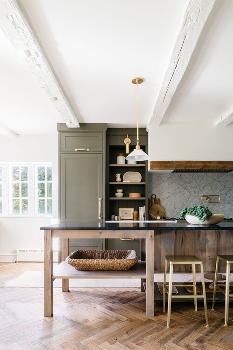 kitchen herringbone flooring with green cabinets