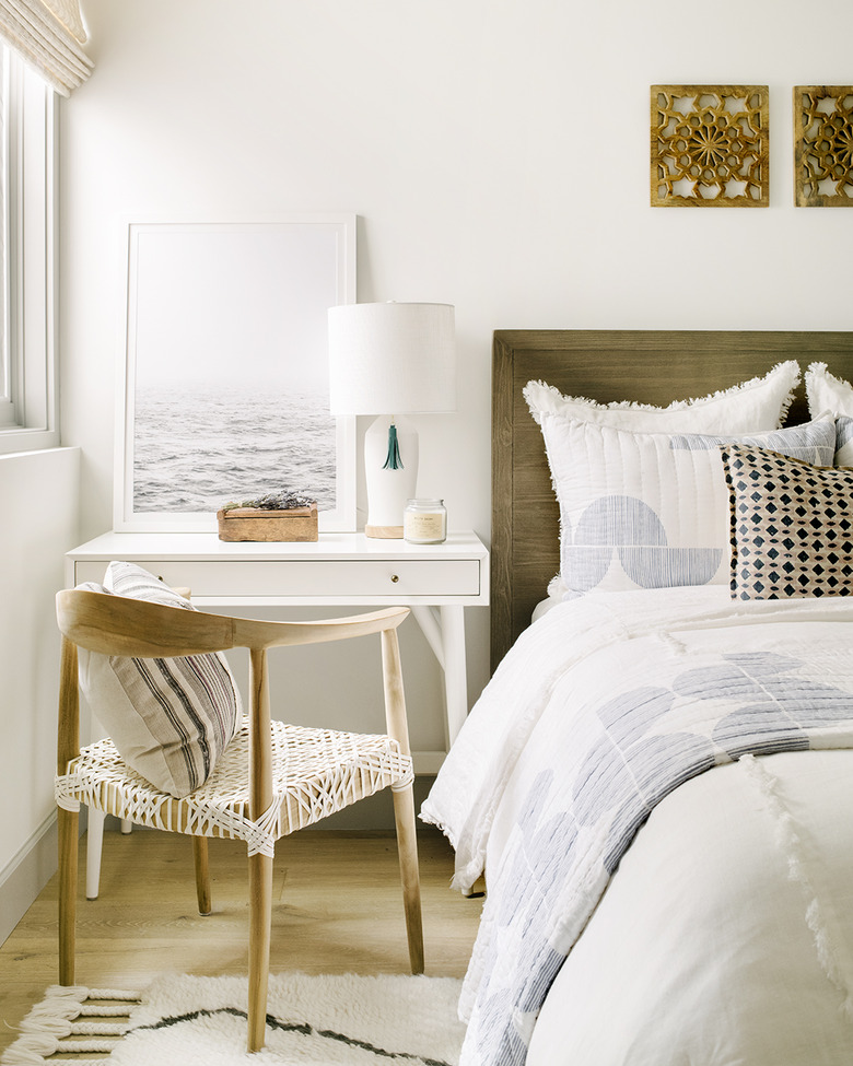 nightstand slash desk in bedroom between bed and window