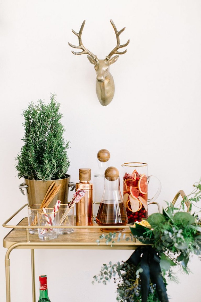 rosemary plant on a brass bar cart