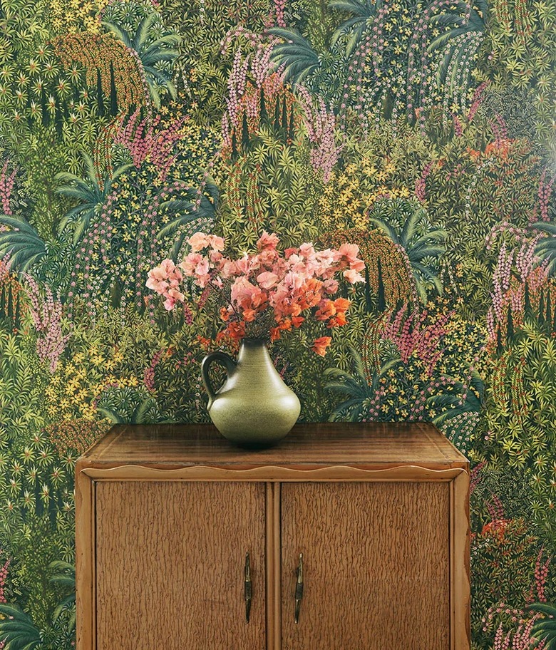 Cole & Son Cascade garden wallpaper featuring pin, yellow, and green florals and foliage.